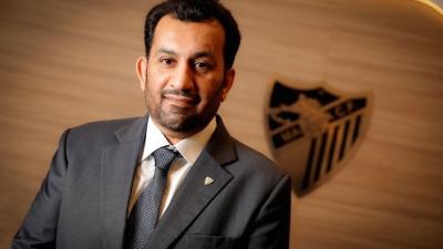 Al-Thani, con el escudo del Málaga de fondo.