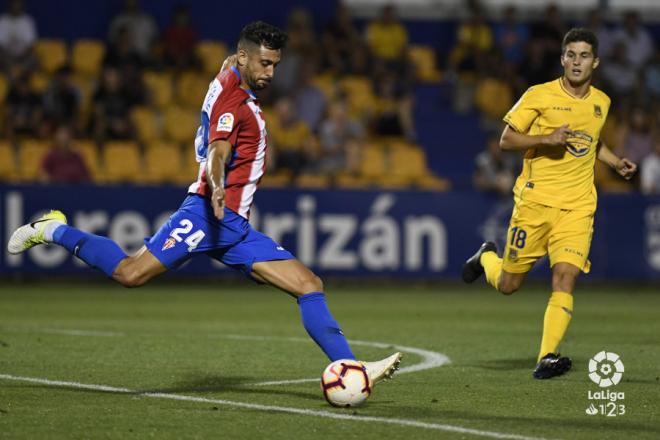 Álex Pérez golpea el balón ante Álvaro Peña en el Alcorcón-Sporting (Foto: LaLiga).