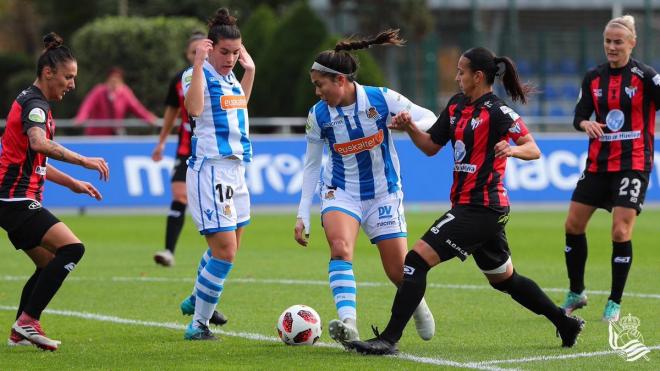 Kiana Palacios intentando escaparse de una jugadora del Sporting de Huelva (Foto: Real Sociedad)