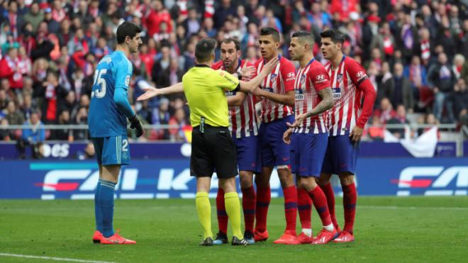 Los jugadores del Atlético de Madrid protestan una acción de Estrada Fernández.