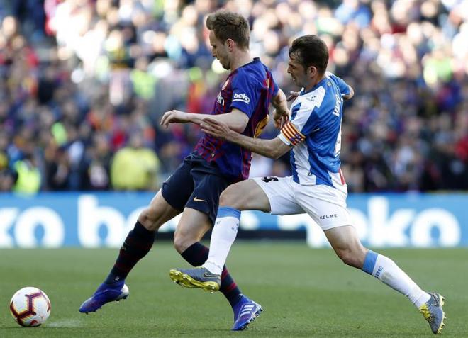 Rakitic avanza con el balón ante Víctor Sánchez.