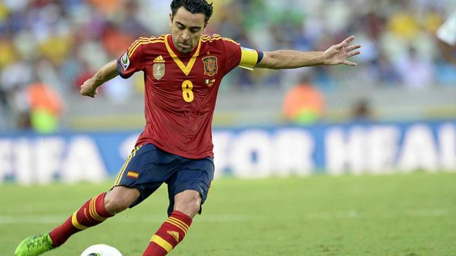 Xavi Hernández golpea el balón en un partido con la selección española.