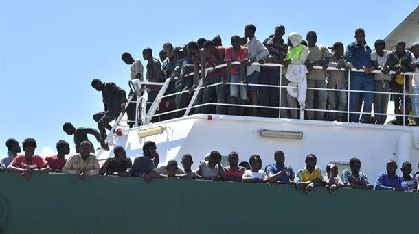 Varios migrantes ocupan la cubierta de un barco.