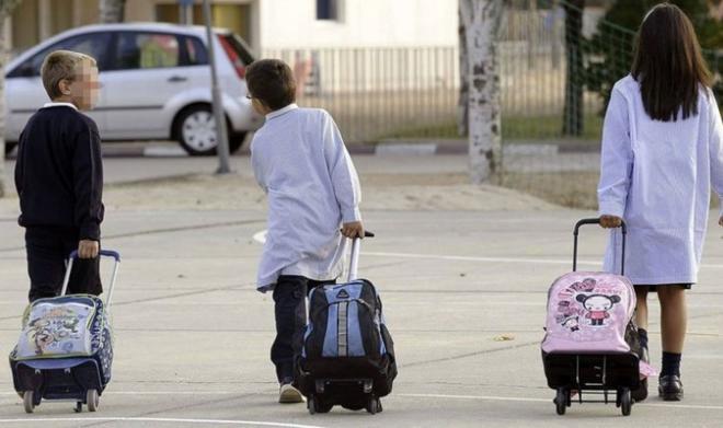 Unos niños llegando a su colegio.