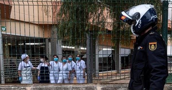 Policía junto a unos sanitarios (Foto: EFE)