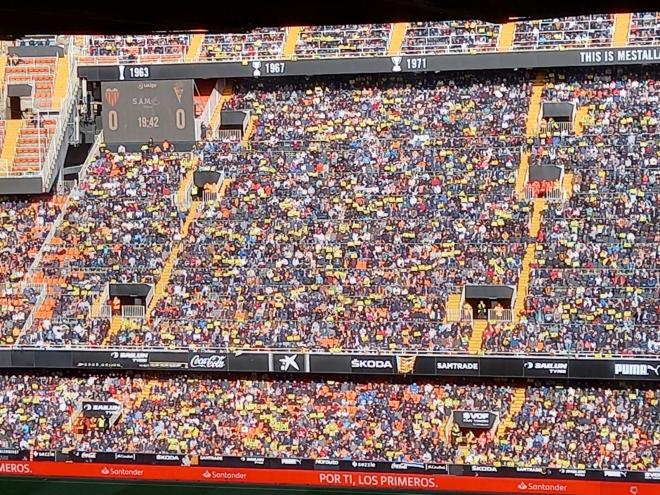 La afición valencianista levanta carteles amarillos en contra de Peter Lim y se quejan del reparto de las entradas