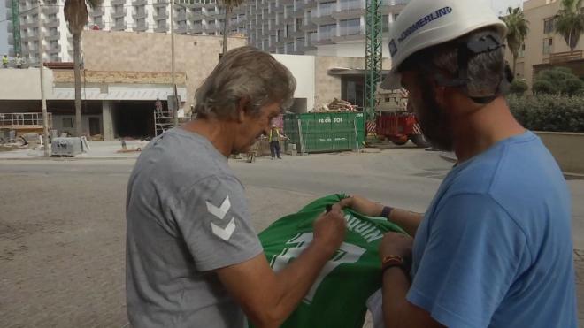 Pellegrini firma la camiseta de Joaquín a un obrero antes de entrar al hotel de concentración en Cádiz