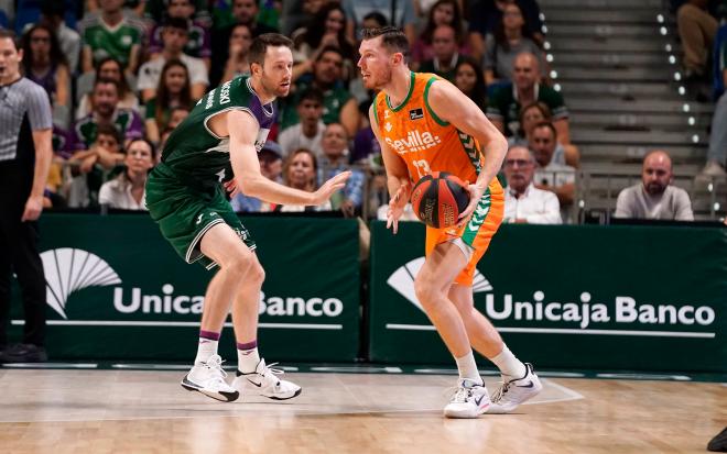 Kalinoski defiende ante un jugador del Betis (Foto: Real Betis Basket).