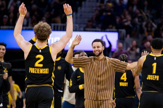 Curry celebrando con la estrella de la noche de la NBA.
