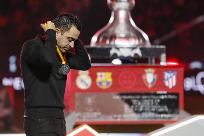 Xavi quitándose la medalla de subcampeón de la Supercopa de España (Foto: EFE).