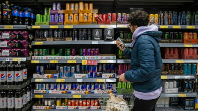 Un adolescente en la sección de bebidas energéticas de un supermercado (Europa Press).