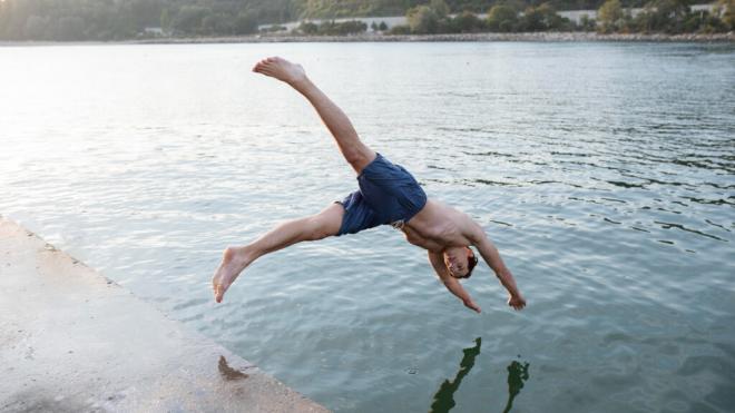 Joven tirándose de cabeza en un pantano (Foto: Freepik)