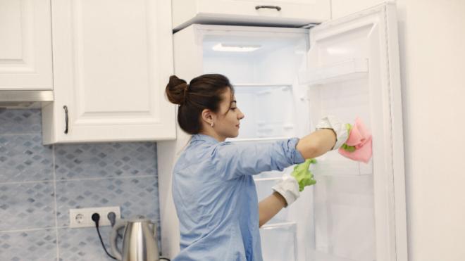 Mujer limpiando nevera (Foto: Freepik)