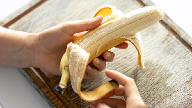 Imagen de archivo de persona pelando un plátano (Foto: Freepik)