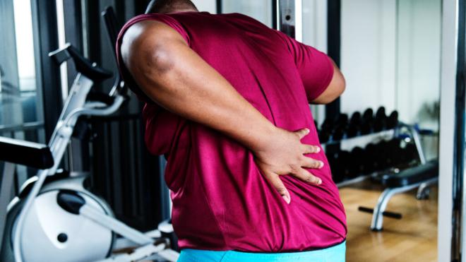 Hombre en el gimnasio con dolor de espalda (Foto: Freepik)