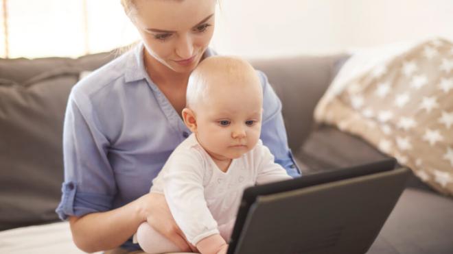 Madre con un bebé jugando con una pantalla (Foto: Freepik)
