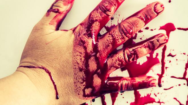 Mano manchada de sangre falsa tocando una pared (Foto: Freepik)