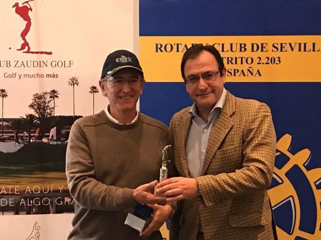 El presidente de Rotary Club de Sevilla, Jesús de Frutos, hace entrega del trofeo a  uno de los ganadores en el Torneo de Golf.